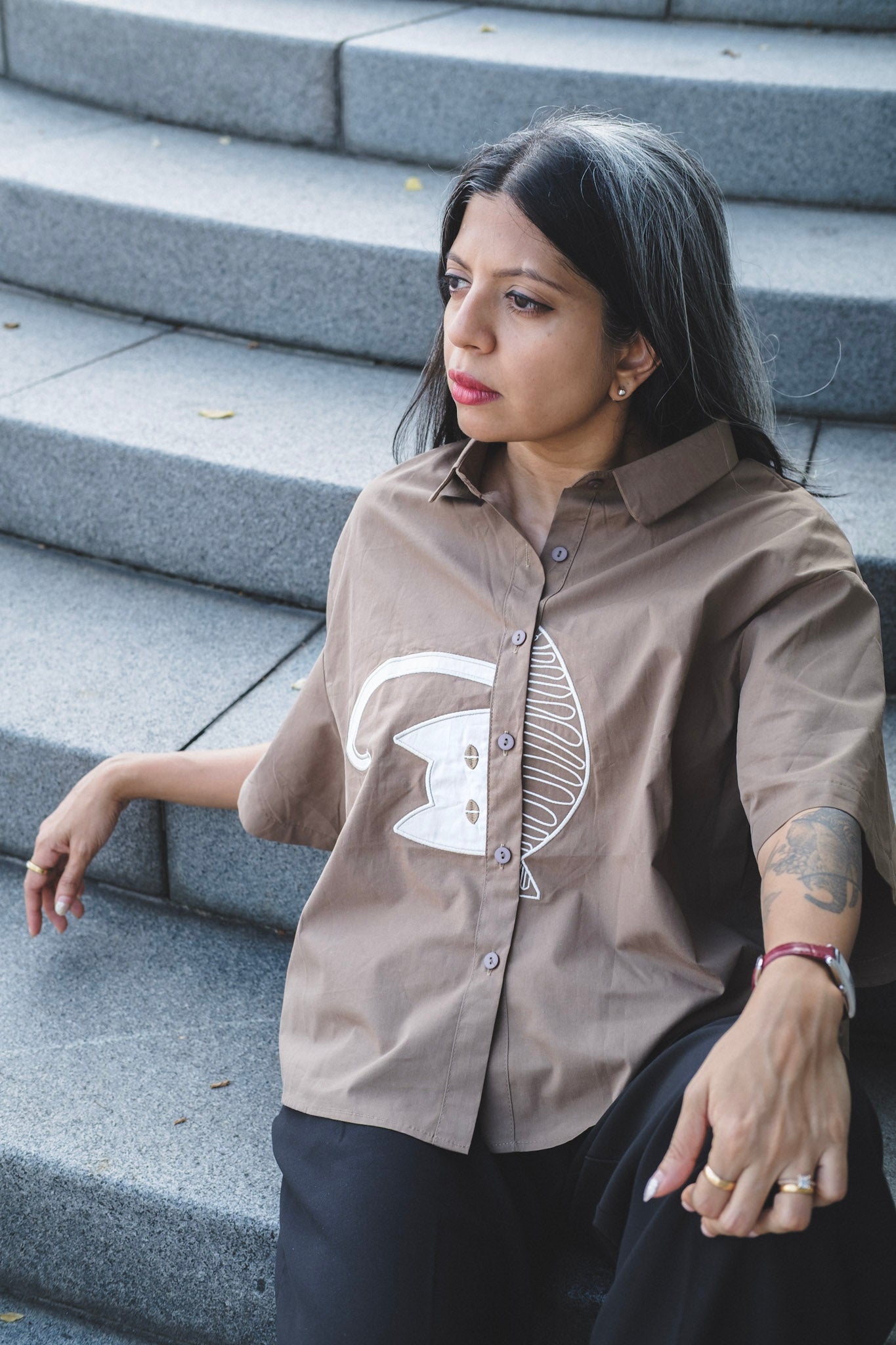 Japanese Street style box shirt with half sleeves and a cat embroidered in the front worn by a woman 
