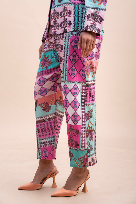 side view of pink and purple geometric printed trousers for women in regular fit and ankle length. 